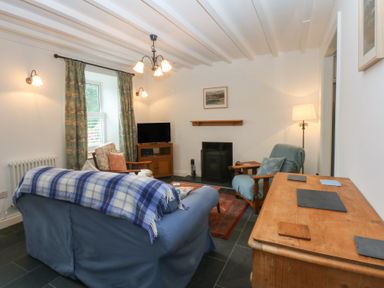 A living room with a sofa and television at Chandos in Dolwyddelan