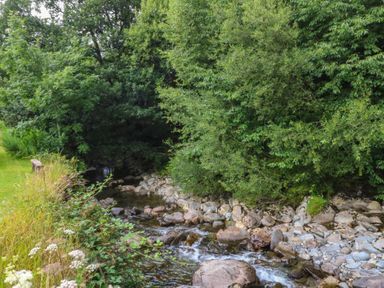 A stream with rocks and trees at Chandos in Dolwyddelan