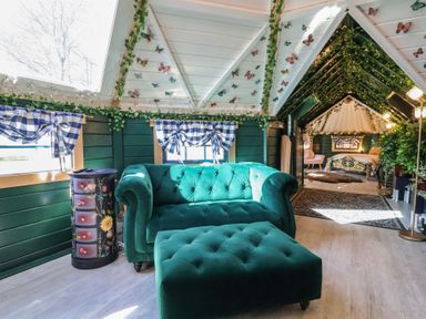 A living room with a sofa and ottoman at Applejacks Orchard in Holywell