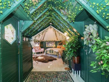 A bedroom with a bed and plants at Applejacks Orchard in Holywell