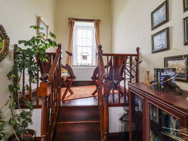 A small seating area with wooden chairs near a window at High Shaftoe in Ponteland