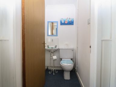A bathroom with a sink and toilet at Wingelock Rhosneigr