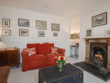A living room with a sofa and coffee table at 84 Fore Street 