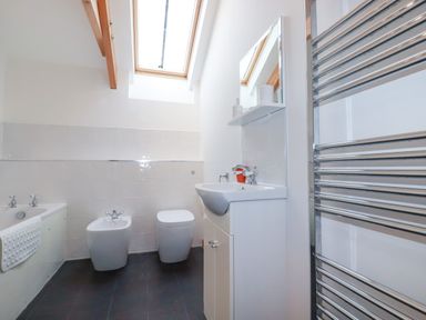 A bathroom with a bathtub bidet toilet sink and heated towel rail at The Orchard in Cardinham