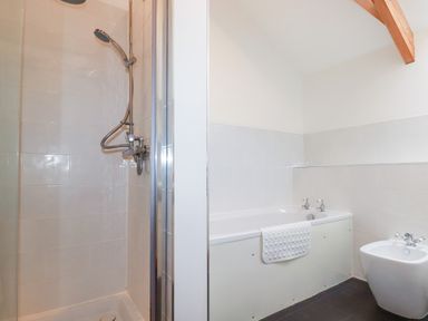 A bathroom with a shower cubicle bathtub and bidet at The Orchard Cardinham