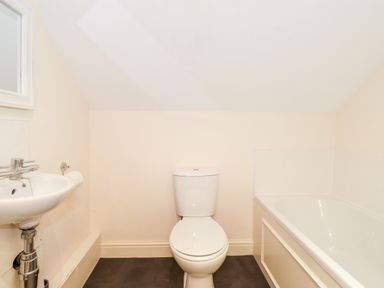 A bathroom with a toilet sink and bathtub at Church View in Grange-Over-Sands