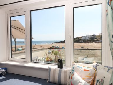 A living room with a view of the beach and sea at 4 Burgh Island Causeway Bigbury