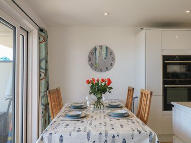 A dining room with a table and chairs at 4 Burgh Island Causeway in Bigbury