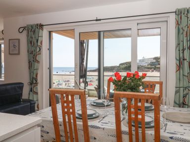 A dining room with a table set for a meal at 4 Burgh Island Causeway Bigbury