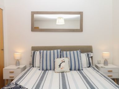 A bedroom with a bed and pillows at 4 Burgh Island Causeway Bigbury