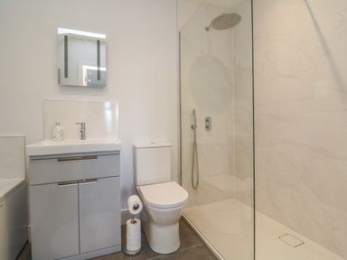 A bathroom with a sink vanity unit toilet and walk in shower at Linden View in Combe Martin