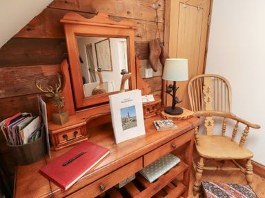 A dressing area with a mirror and lamp at Bruno's Bothy Middleton near Belford