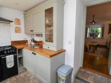 A kitchen with cabinets and stove at Bruno's Bothy Middleton near Belford