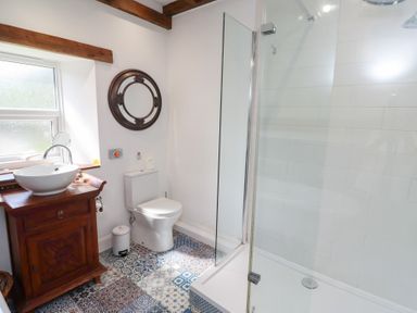 A bathroom with a sink and shower at Bruno's Bothy in Middleton near Belford