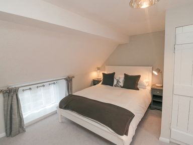 A bedroom with a double bed and side tables with lamps at York House in Thornton Dale