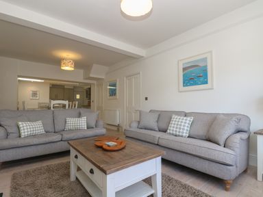 A living room with two grey sofas and a wooden coffee table at 21 Passage Street formerly Panacea in Fowey