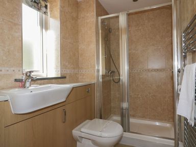 A bathroom with a sink vanity unit toilet shower enclosure and heated towel rail at Lower Mellan Barn Coverack