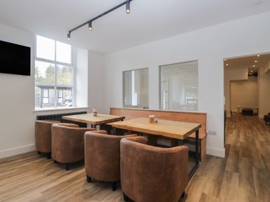 A dining room featuring a table and chairs at Apartment 1 in Keswick