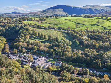 An aerial view of houses and fields in a rural area at Apartment 2 in Keswick