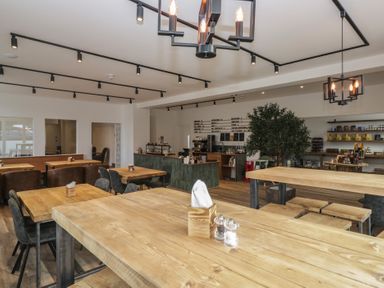 A cafe with tables and a coffee counter at Apartment 3 in Keswick