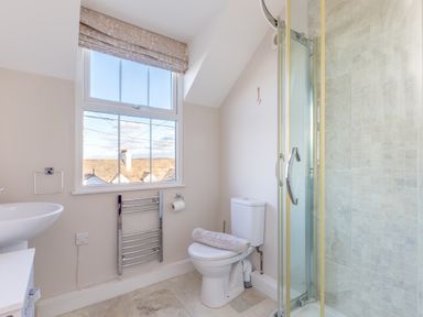 A bathroom with a toilet towel radiator sink and shower at Tre Lowen in Port Isaac