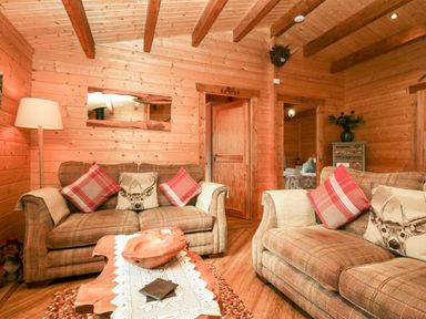 A living room with two sofas and a wooden coffee table at Ballinorig Lodge in Cleator Moor