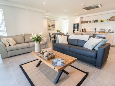 A living room with two sofas and a wooden coffee table at 31 Cliff Edge in Newquay
