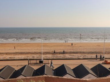 A beach with sand and people walking at Apt 3 @ Hunter's Quay Bridlington