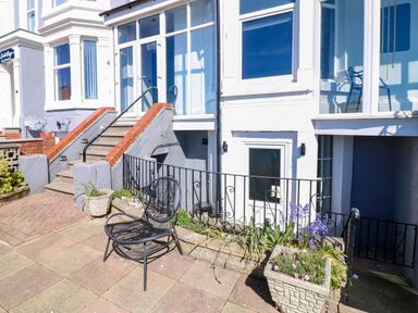 An outdoor area with steps and a chair at Apt 3 @ Hunter's Quay in Bridlington