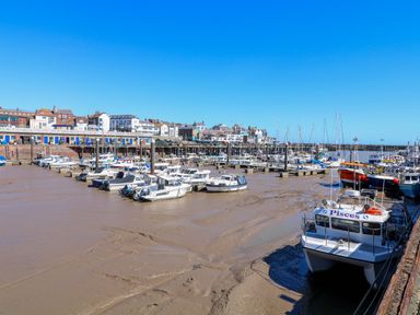 A marina with boats and buildings at Apt 6 @ Hunter's Quay Bridlington