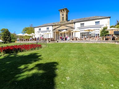 A garden with a restaurant building and outdoor seating at Apt 6 @ Hunter's Quay Bridlington