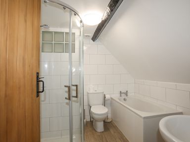 A bathroom with a shower enclosure a toilet a bathtub and a sink at 5 The Crescent in Caernarfon