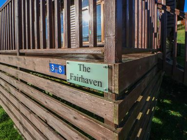 A wooden corner structure with a sign reading The Fairhaven and blue number plaques 3 and 8 at The Fairhaven in Tunstall near Catterick North Yorkshire