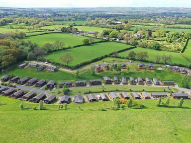 An aerial view of a residential area with multiple houses and green fields at The Fairhaven in Tunstall near Catterick North Yorkshire