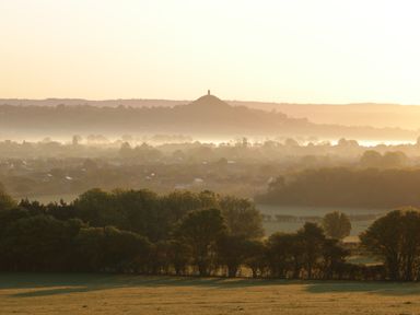 A landscape with trees and distant hill with monument at Pear Tree Lodge in Combe near Langport