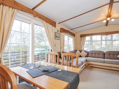 A living room with a table and sofa at Little Malory St Giles-On-The-Heath