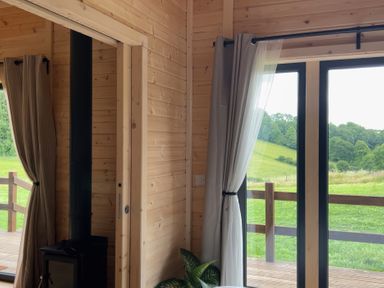 A room featuring a stove and window at Primrose, Higher Wambrook near Chard
