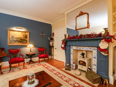 A living room with a fireplace and seating at White House