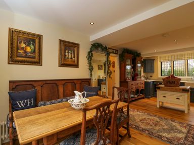 A dining room with a wooden table and chairs at White House