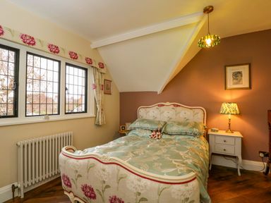 A bedroom with a bed and bedside table at White House