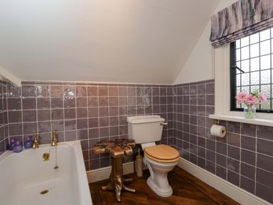 A bathroom with a bathtub a toilet and a sink at White House