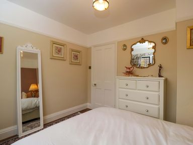 A bedroom with a dressing table and a mirror at White House