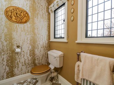 A bathroom with a toilet and windows at White House