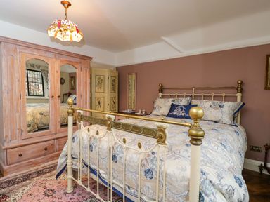 A bedroom with a bed and wardrobe at White House