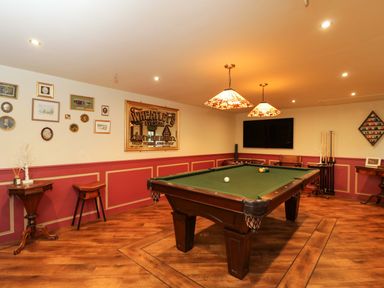 A game room with a pool table and wall decor at The White House