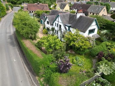 A house with garden and trees near a road at White House