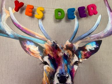 A colorful painting of a deer's head with antlers and felt letters spelling yes deer above it at Yes Deer in Ashbourne