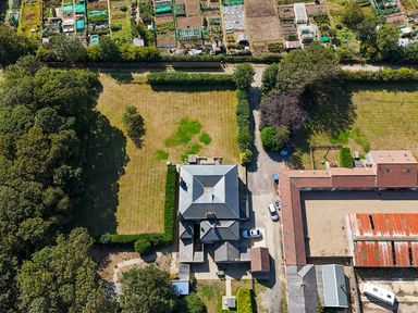 An aerial view of a house with a garden and vegetable plots at The Pheasantry in Flamborough