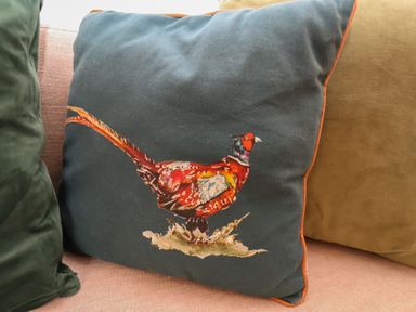 A cushion with a pheasant illustration at The Pheasantry in Flamborough