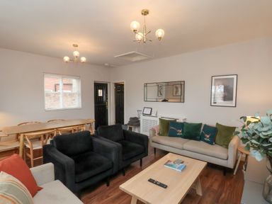 A living room with a dining table and chairs at The Pheasantry in Flamborough